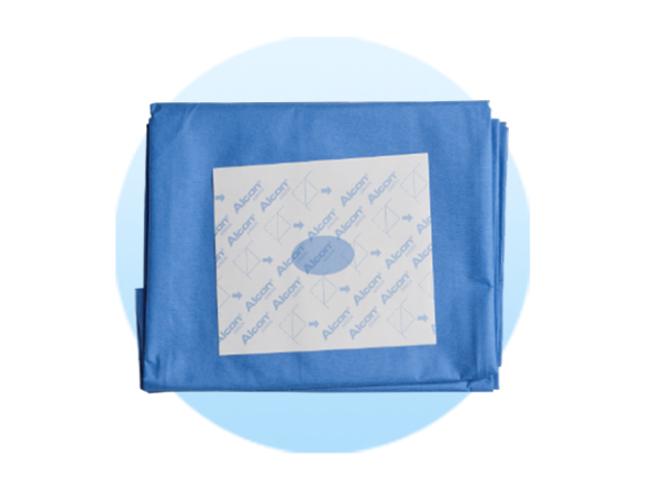 Paños quirúrgicos doblados sobre un fondo circular azul claro.